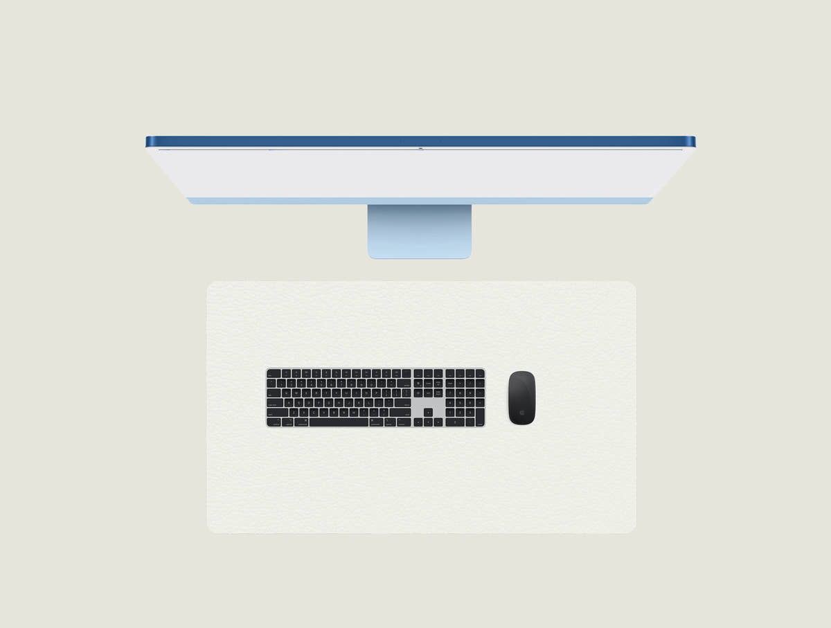 Moon White leather keyboard mat with a keyboard and mouse placed on top