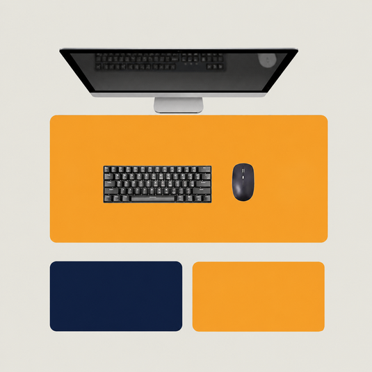 Shappa Dual-Sided Desk Mat in orange, shown with a keyboard and mouse plus the deep blue and yellow colour options