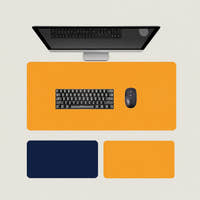Shappa Dual-Sided Desk Mat in orange, shown with a keyboard and mouse plus the deep blue and yellow colour options