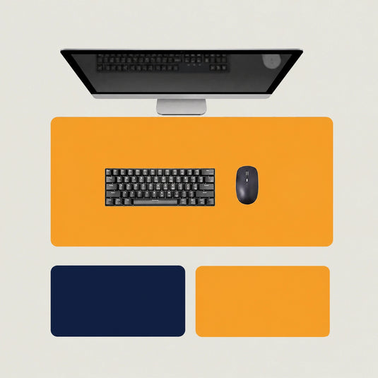 Shappa Dual-Sided Desk Mat in orange, shown with a keyboard and mouse plus the deep blue and yellow colour options