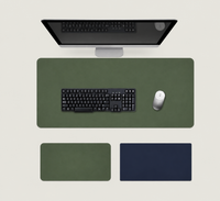 Shappa Dual-Sided Desk Mat in green, shown with a keyboard and mouse plus the green and navy colour options