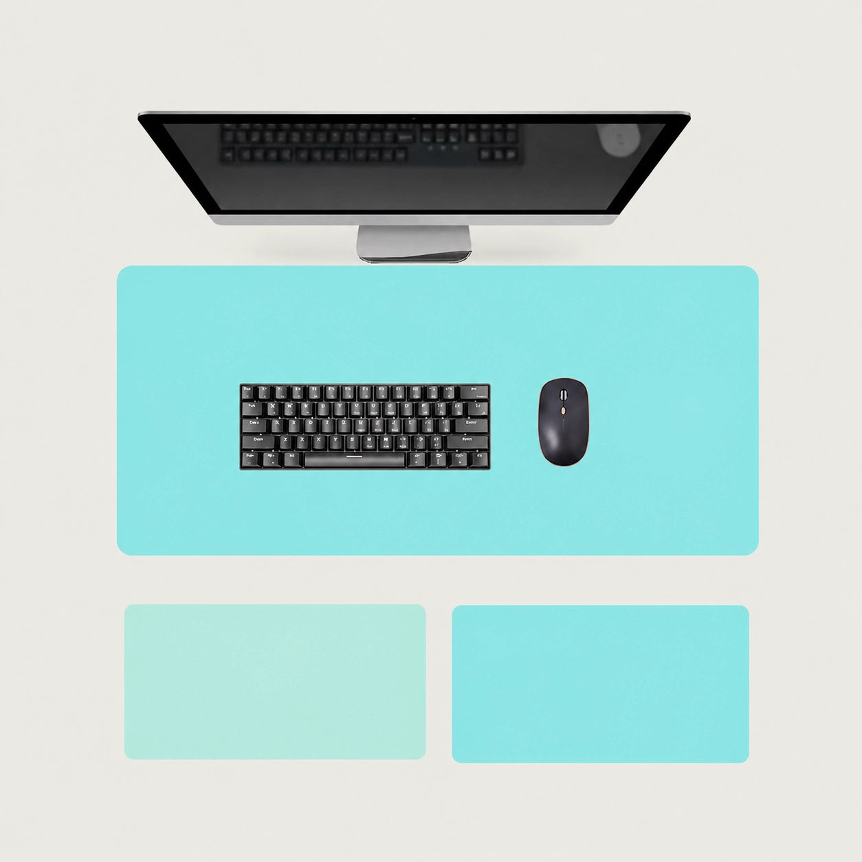 Shappa Dual-Sided Desk Mat in turquoise, shown with a keyboard and mouse plus the light green and lake blue colour options