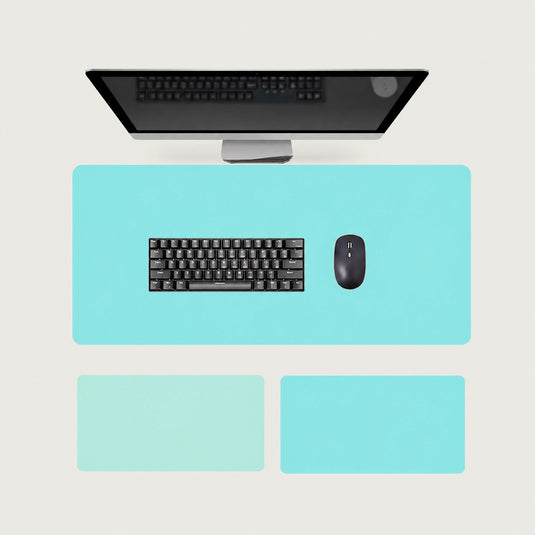 Shappa Dual-Sided Desk Mat in turquoise, shown with a keyboard and mouse plus the light green and lake blue colour options
