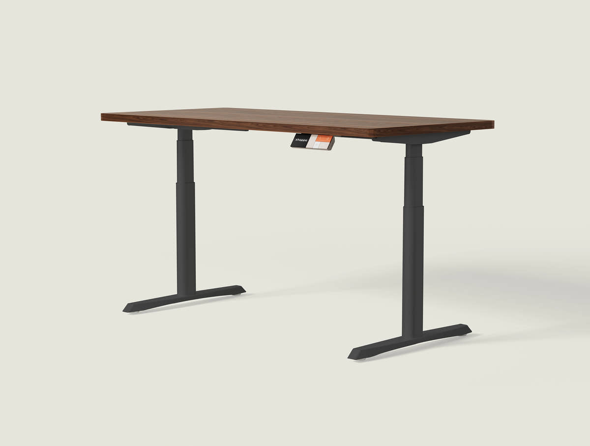 Shappa MO2 electric standing desk with walnut tabletop and black frame - dual motor oval tube angled studio shot