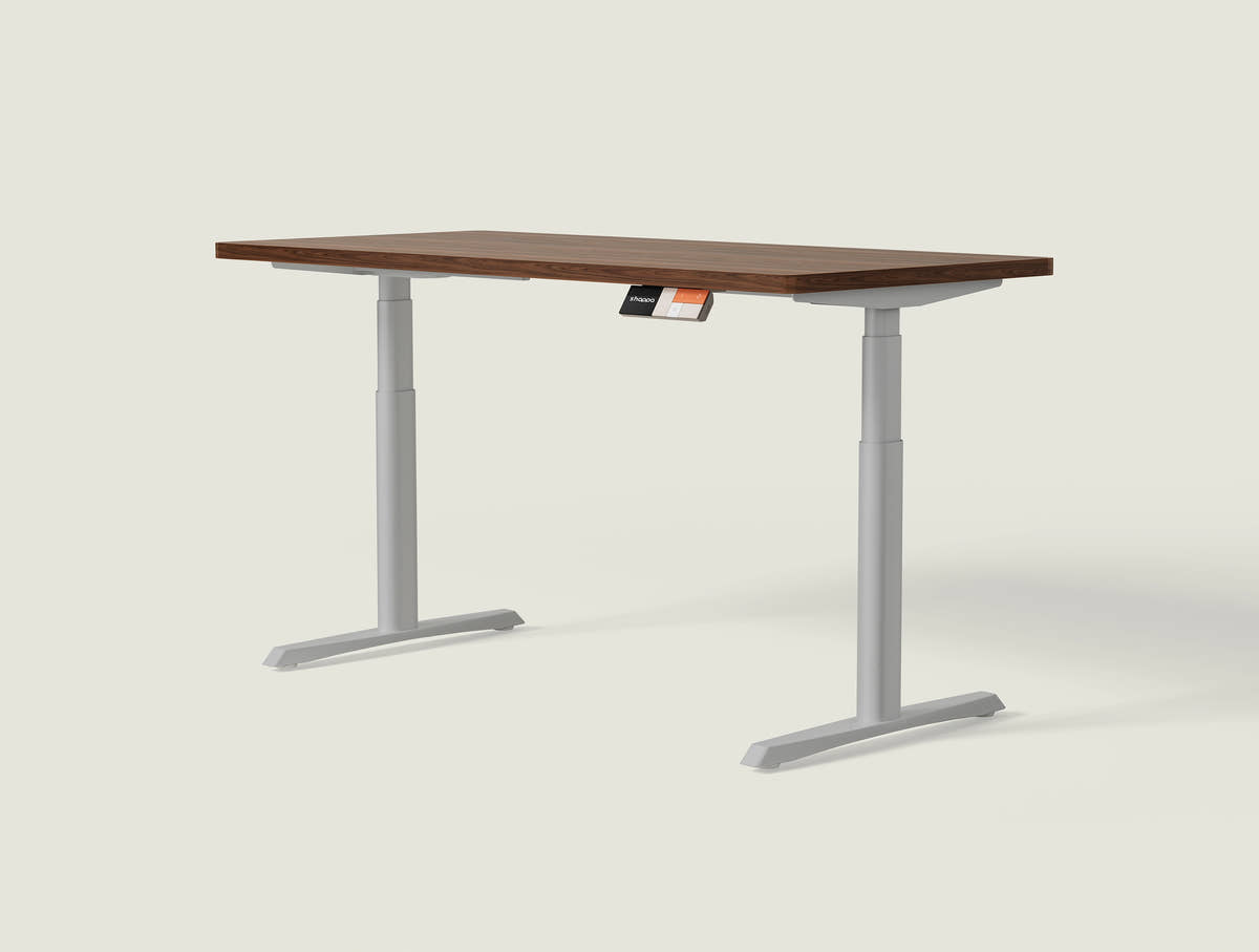 Shappa MO2 electric standing desk with walnut tabletop and grey frame - dual motor oval tube angled studio shot