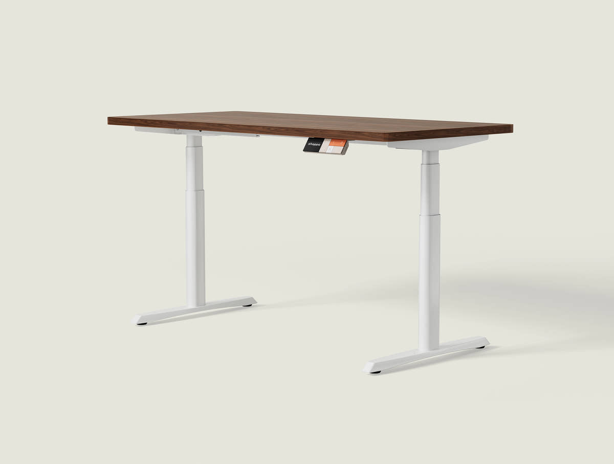 Shappa MO2 electric standing desk with walnut tabletop and white frame - dual motor oval tube angled studio shot