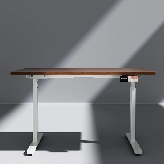 Shappa MS2 electric standing desk with walnut tabletop and white frame - front angle studio shot