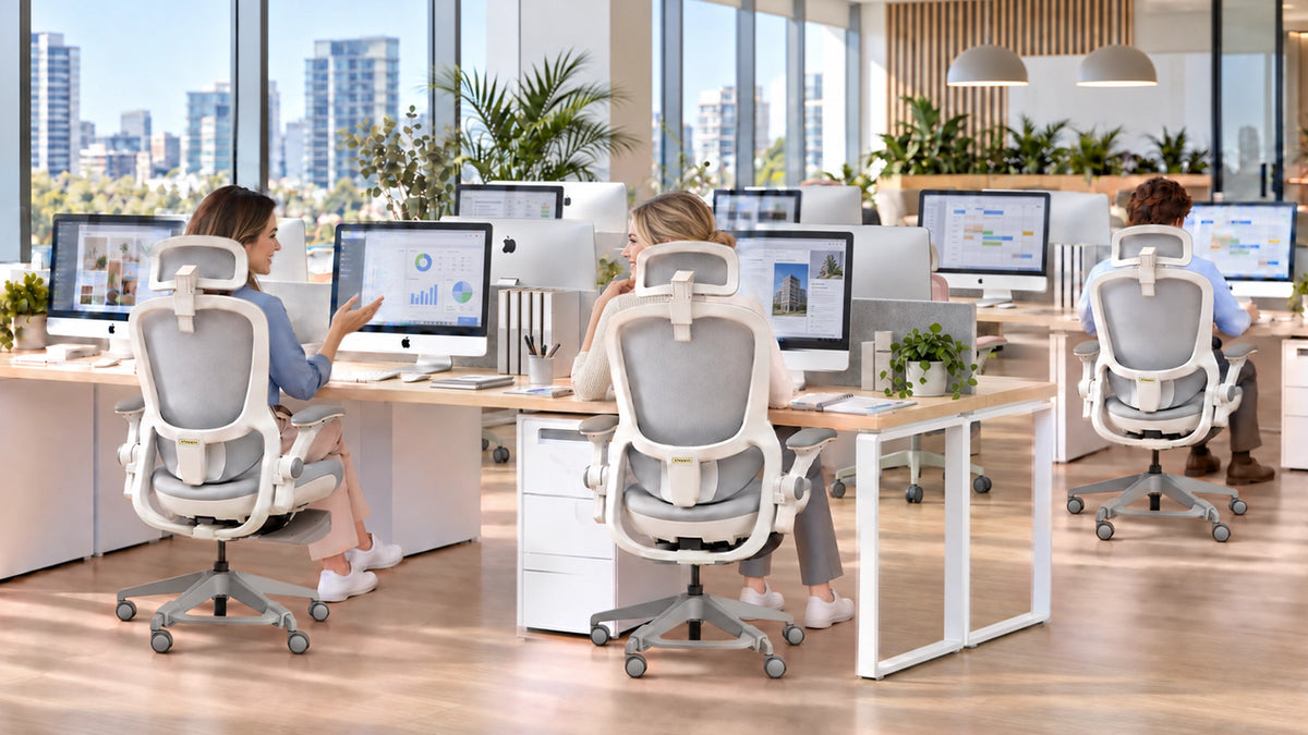 Colleagues seated in silver P1 Lady chairs in a bright shared office