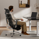 Man sitting in Shappa Spencer ergonomic desk chair working at a standing desk in a home office