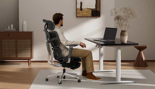 Man sitting in Shappa Spencer ergonomic desk chair working at a standing desk in a home office