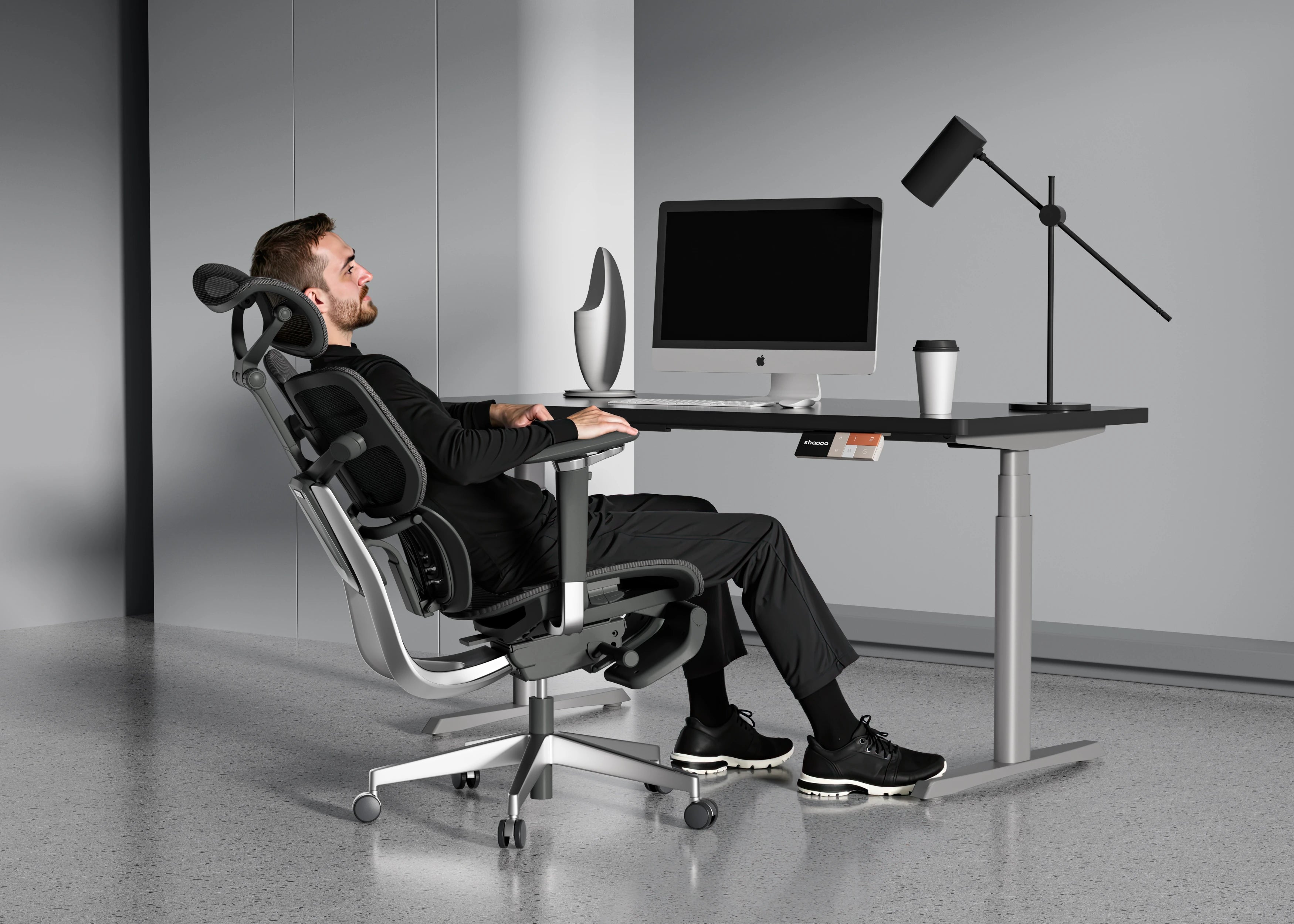 Man reclining in Shappa Spencer black ergonomic office chair for a break at his desk