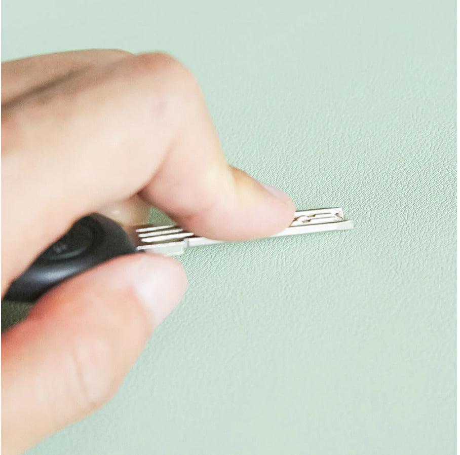 Testing the desk mat's scratch-resistant surface with a metal comb